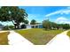 Charming single-story home with a well-manicured lawn, mature trees, and a two-car garage, blending curb appeal and functionality at 3907 Orchard Hill Cir, Palm Harbor, FL 34684