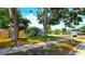 Charming single-Gathering home with a well-manicured lawn, mature trees, and a welcoming sidewalk at 3907 Orchard Hill Cir, Palm Harbor, FL 34684
