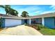 Beautiful single-story home with a two-car garage and colorful landscaping at 3907 Orchard Hill Cir, Palm Harbor, FL 34684