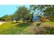 Well-maintained house exterior with a green lawn and landscaping, creating a welcoming curb appeal at 3907 Orchard Hill Cir, Palm Harbor, FL 34684
