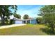 Inviting single-story home with a two-car garage, beautifully landscaped yard, and a cozy, well-maintained exterior at 3907 Orchard Hill Cir, Palm Harbor, FL 34684