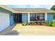 Charming single-story home with a well-manicured front yard and blue painted exterior at 3907 Orchard Hill Cir, Palm Harbor, FL 34684