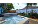 Relaxing hot tub in a beautiful backyard with lush greenery and a well-maintained fence at 3907 Orchard Hill Cir, Palm Harbor, FL 34684