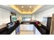 Well-lit kitchen featuring white cabinetry, dark countertops, and stainless steel appliances at 3907 Orchard Hill Cir, Palm Harbor, FL 34684