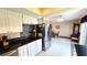 Bright kitchen showcasing white cabinets, stainless steel refrigerator, and adjacent dining area at 3907 Orchard Hill Cir, Palm Harbor, FL 34684