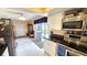 Open kitchen with white cabinets, stainless steel appliances, and sliding glass doors to the outdoors at 3907 Orchard Hill Cir, Palm Harbor, FL 34684
