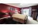 Spacious main bedroom with a comfortable bed and a sliding glass door with backyard access at 3907 Orchard Hill Cir, Palm Harbor, FL 34684