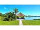 Scenic lakeside pavilion with seating and a tranquil atmosphere, perfect for relaxation and enjoying the water view at 3907 Orchard Hill Cir, Palm Harbor, FL 34684