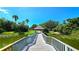 Picturesque lakeside pavilion accessible by a wooden walkway, offering a serene spot amidst the lush landscape at 3907 Orchard Hill Cir, Palm Harbor, FL 34684
