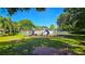Community playground area with swings, slides, climbing structure, and bench seating on green grass at 3907 Orchard Hill Cir, Palm Harbor, FL 34684