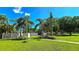 Beautiful community park with playground, swaying palms, grassy lawn, and inviting landscaping at 3907 Orchard Hill Cir, Palm Harbor, FL 34684