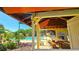 Community Pool. Covered pool area includes picnic tables and benches, plus lots of lounge chairs surrounding the pool at 3907 Orchard Hill Cir, Palm Harbor, FL 34684