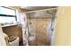 Tiled shower featuring a rainfall shower head and a built-in shelf at 3907 Orchard Hill Cir, Palm Harbor, FL 34684