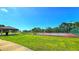 Community tennis courts and a covered pavilion, providing recreational opportunities in a well-maintained park setting at 3907 Orchard Hill Cir, Palm Harbor, FL 34684