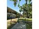 Charming condo with a lush green lawn and bench seating area for relaxing outdoors at 4051 58Th N St # 241C, Kenneth City, FL 33709