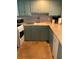 Classic kitchen features light blue cabinets, tile backsplash, and laminate countertops at 4051 58Th N St # 241C, Kenneth City, FL 33709