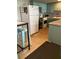 Cozy kitchen features white appliances, light blue cabinets, and tile floors at 4051 58Th N St # 241C, Kenneth City, FL 33709