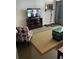 Comfortable living room with a TV, accent chair, and charming decor at 4051 58Th N St # 241C, Kenneth City, FL 33709