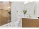 Modern bathroom featuring a glass-enclosed shower, a floating vanity, and sleek fixtures at 411 37Th S St, St Petersburg, FL 33711