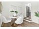 Dining area featuring a white table, modern chairs, and view of the kitchen with stainless steel appliances at 411 37Th S St, St Petersburg, FL 33711