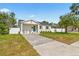 Charming home featuring a well-manicured lawn and a welcoming entrance at 411 37Th S St, St Petersburg, FL 33711