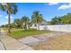 Cozy home featuring a well-maintained lawn and a secure, white privacy fence at 411 37Th S St, St Petersburg, FL 33711