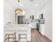 Well-lit kitchen featuring modern appliances, white cabinets, and stylish light fixtures at 411 37Th S St, St Petersburg, FL 33711