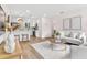 Bright and open living room featuring modern decor and hardwood flooring with kitchen view at 411 37Th S St, St Petersburg, FL 33711