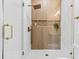 Elegant shower featuring a glass door, rainfall showerhead, and built-in niche for toiletries at 411 37Th S St, St Petersburg, FL 33711