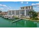 Aerial view of building and docks on the water, with multiple boat slips at 415 Island Way # 303, Clearwater Beach, FL 33767