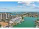 Aerial view of building and community, featuring waterfront views and boat docks at 415 Island Way # 303, Clearwater Beach, FL 33767