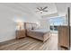 Relaxing bedroom with waterfront view, hardwood floors, and stylish bedside table at 415 Island Way # 303, Clearwater Beach, FL 33767