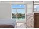 Bedroom featuring water views and a dresser for ample storage at 415 Island Way # 303, Clearwater Beach, FL 33767