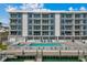 Building exterior featuring pool, waterfront, and multiple levels of balconies at 415 Island Way # 303, Clearwater Beach, FL 33767