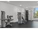 Modern gym with weight machines overlooking tropical foliage seen from the large window at 415 Island Way # 303, Clearwater Beach, FL 33767
