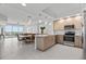 Open kitchen with stainless appliances flows into a dining area with water views at 415 Island Way # 303, Clearwater Beach, FL 33767