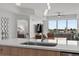 Open-concept kitchen featuring pendant lighting and views of the living area and waterway at 415 Island Way # 303, Clearwater Beach, FL 33767