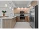 Modern kitchen featuring stainless steel appliances, light wood cabinets, and quartz countertops at 415 Island Way # 303, Clearwater Beach, FL 33767
