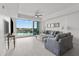 Bright living room features water views, neutral decor, tile floors, and plenty of seating at 415 Island Way # 303, Clearwater Beach, FL 33767