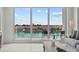 Living room area with water views and access to outdoor balcony at 415 Island Way # 303, Clearwater Beach, FL 33767