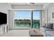 Living room area with water views and access to outdoor balcony at 415 Island Way # 303, Clearwater Beach, FL 33767