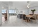 Bright living room with water views, tile flooring, and open access to the kitchen at 415 Island Way # 303, Clearwater Beach, FL 33767