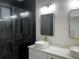 Sleek bathroom featuring a stylish vanity with double sinks, elegant mirrors, and a walk-in shower at 4241 E Palifox St, Tampa, FL 33610