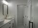 Bright bathroom with double vanity, modern fixtures, and access to the powder room at 4241 E Palifox St, Tampa, FL 33610