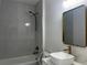 Elegant bathroom featuring white marble tile, a tub, and bronze fixtures at 4241 E Palifox St, Tampa, FL 33610