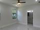 Serene bedroom showcasing contemporary fixtures and a view to the outdoors via a large window at 4241 E Palifox St, Tampa, FL 33610