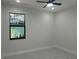 This is a bedroom with gray and white marble flooring and a large window at 4241 E Palifox St, Tampa, FL 33610