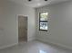 A bright bedroom with a view outside the window and a closet at 4241 E Palifox St, Tampa, FL 33610