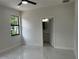 A bright bedroom with a view outside the window and an ensuite bathroom at 4241 E Palifox St, Tampa, FL 33610