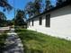 Home exterior featuring a manicured lawn and white paint at 4241 E Palifox St, Tampa, FL 33610